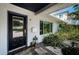 Inviting entrance featuring a stylish front door, elegant lantern, and lush landscaping at 333 Belleair Ne Dr, St Petersburg, FL 33704
