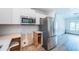 Bright kitchen with stainless steel appliances, white cabinetry, and herringbone backsplash details at 333 Belleair Ne Dr, St Petersburg, FL 33704