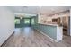 Bright open floor plan featuring wood-look tile flooring, recessed lights, and a spacious kitchen area at 333 Belleair Ne Dr, St Petersburg, FL 33704