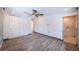 Main bedroom featuring wood-look flooring, ceiling fan, and ensuite bathroom with tiled shower and toilet at 333 Belleair Ne Dr, St Petersburg, FL 33704