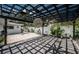 Under pergola, patio with hanging decor, ceiling fan, and bright tropical landscaping create an inviting outdoor space at 333 Belleair Ne Dr, St Petersburg, FL 33704