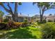 Traditional home with lush landscaping, trees, a green lawn, and a charming entryway at 3422 W San Pedro St, Tampa, FL 33629