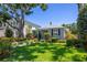 Landscaped front yard with green lawn, plants, and a charming single-story home at 3422 W San Pedro St, Tampa, FL 33629