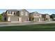Modern townhome exterior featuring neutral tones, individual garages, and well-maintained landscaping at 36013 Joseph Blake St, Zephyrhills, FL 33541