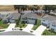 Aerial view of neighborhood home with two car garage and inviting front porch at 36398 Spanish Rose Dr, Dade City, FL 33525