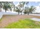 Large backyard featuring a white fence and grass at 36398 Spanish Rose Dr, Dade City, FL 33525