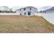 Spacious backyard features white fencing and sliding glass door access to home at 36398 Spanish Rose Dr, Dade City, FL 33525