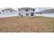 Spacious backyard features white fencing and sliding glass door access to home at 36398 Spanish Rose Dr, Dade City, FL 33525