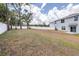 Large backyard with a white fence, grass and trees provide privacy at 36398 Spanish Rose Dr, Dade City, FL 33525