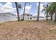Expansive backyard features white fence for privacy and shaded trees at 36398 Spanish Rose Dr, Dade City, FL 33525