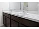 Bathroom features a double vanity with dark wood cabinets and white countertops at 36398 Spanish Rose Dr, Dade City, FL 33525