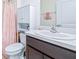 Cozy bathroom with classic fixtures and features a shower with a floral curtain at 36398 Spanish Rose Dr, Dade City, FL 33525