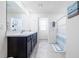 Bathroom featuring double sinks, a large mirror, and a shower with a blue curtain at 36398 Spanish Rose Dr, Dade City, FL 33525