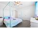 Bright bedroom features a light blue canopy bed and neutral color scheme at 36398 Spanish Rose Dr, Dade City, FL 33525