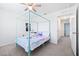 Bright bedroom features a light blue canopy bed and neutral color scheme at 36398 Spanish Rose Dr, Dade City, FL 33525