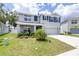Two-story home with a well-kept lawn, lush landscaping, attached garage, and inviting curb appeal at 36398 Spanish Rose Dr, Dade City, FL 33525