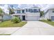 Charming two-story home with a well-manicured lawn, attached garage and neatly trimmed shrubbery at 36398 Spanish Rose Dr, Dade City, FL 33525