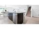 Open-concept kitchen with an island and stainless steel dishwasher, blending functionality with modern design at 36398 Spanish Rose Dr, Dade City, FL 33525