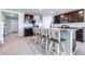 Modern kitchen with an island, stainless steel appliances, and dark wood cabinets at 36398 Spanish Rose Dr, Dade City, FL 33525
