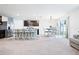 Open-concept kitchen featuring a central island with seating, stainless steel appliances, and an adjacent dining area at 36398 Spanish Rose Dr, Dade City, FL 33525