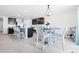 Bright kitchen featuring stainless appliances, dark cabinets, and a cozy dining area with decorative lighting at 36398 Spanish Rose Dr, Dade City, FL 33525