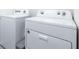 Laundry room view with white Whirlpool washer and dryer at 36398 Spanish Rose Dr, Dade City, FL 33525