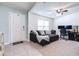 Cozy living room featuring a comfortable sofa, modern ceiling fan, and a view of the home's entrance at 36398 Spanish Rose Dr, Dade City, FL 33525