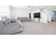 Spacious living room with plush carpeting, neutral decor, and a staircase leading to the upper level at 36398 Spanish Rose Dr, Dade City, FL 33525