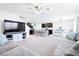 Open-concept living space with a comfortable sofa, TV area, and kitchen with stainless steel appliances at 36398 Spanish Rose Dr, Dade City, FL 33525