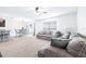 Bright living space featuring a comfortable sofa, large window, and dining area near the kitchen at 36398 Spanish Rose Dr, Dade City, FL 33525
