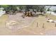 Aerial view of a well-maintained community playground with play equipment and picnic tables at 36398 Spanish Rose Dr, Dade City, FL 33525