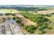 Aerial view showcasing the property's positioning near pond, neighborhood, and borders outlined in red at 36601 Roberts Rd, Dade City, FL 33525