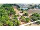 A beautiful aerial view of a vast acreage property with multiple buildings and lovely pond at 36601 Roberts Rd, Dade City, FL 33525