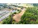 Aerial view highlighting the property's dimensions near a pond, neighborhood, and trees; outlines in red at 36601 Roberts Rd, Dade City, FL 33525