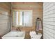 Rustic bathroom featuring a sink, toilet, and a mirror at 36601 Roberts Rd, Dade City, FL 33525