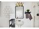 Stylish bathroom with a unique mirror, flowers, vanity, shelf, soft towel, and walk-in shower at 36601 Roberts Rd, Dade City, FL 33525