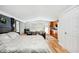Well-lit bedroom featuring a king bed, a sitting area, a kitchen area, hardwood floors and neutral colors at 36601 Roberts Rd, Dade City, FL 33525