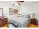 Bedroom with a comfortable bed, dresser, and window with blinds at 36601 Roberts Rd, Dade City, FL 33525