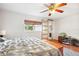 Bedroom features hardwood floors, a sliding glass door, and a view of the backyard at 36601 Roberts Rd, Dade City, FL 33525