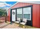 Cozy deck featuring two chairs, a wreath on the door, and a wooden railing, inviting relaxation at 36601 Roberts Rd, Dade City, FL 33525
