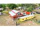 Exterior view features barn-style home with deck, trailer and storage containers in a rural setting at 36601 Roberts Rd, Dade City, FL 33525
