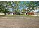 Expansive front yard with mature trees frames this single-story home, offering privacy and a touch of nature at 36601 Roberts Rd, Dade City, FL 33525