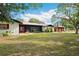 Charming single story home with a lush lawn and mature trees creates a beautiful curb appeal at 36601 Roberts Rd, Dade City, FL 33525