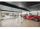 Spacious garage featuring high ceilings, a classic red Shelby Cobra, and a hot tub at 36601 Roberts Rd, Dade City, FL 33525
