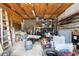 This cluttered garage features a ladder, a metal shelf, a tire, and a lot of boxes and stuff at 36601 Roberts Rd, Dade City, FL 33525