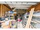 This cluttered garage features a metal shelf and a lot of stuff at 36601 Roberts Rd, Dade City, FL 33525