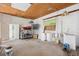 This garage has plywood ceiling, bare walls, and is partially filled with equipment, supplies, and a window at 36601 Roberts Rd, Dade City, FL 33525