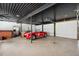 Spacious garage featuring high ceilings and a classic red Shelby Cobra at 36601 Roberts Rd, Dade City, FL 33525