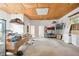 This garage has plywood ceiling, bare walls, and is partially filled with equipment, supplies, and lighting at 36601 Roberts Rd, Dade City, FL 33525