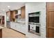 A view of the kitchen with stainless steel ovens and refrigerator and two-tone cabinets at 36601 Roberts Rd, Dade City, FL 33525